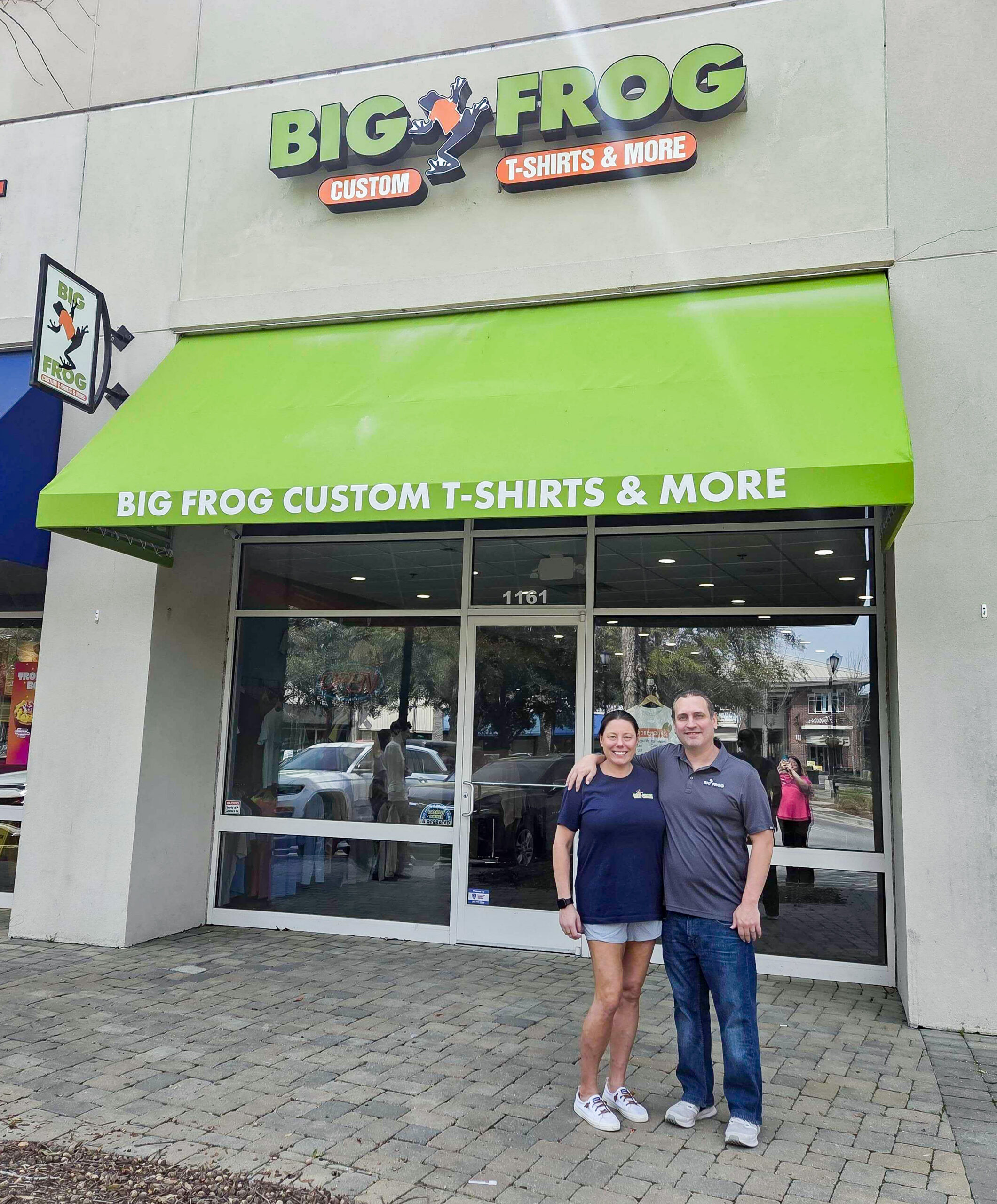 Big Frog store owners, David and Erin Lindgren standing in front of their store.