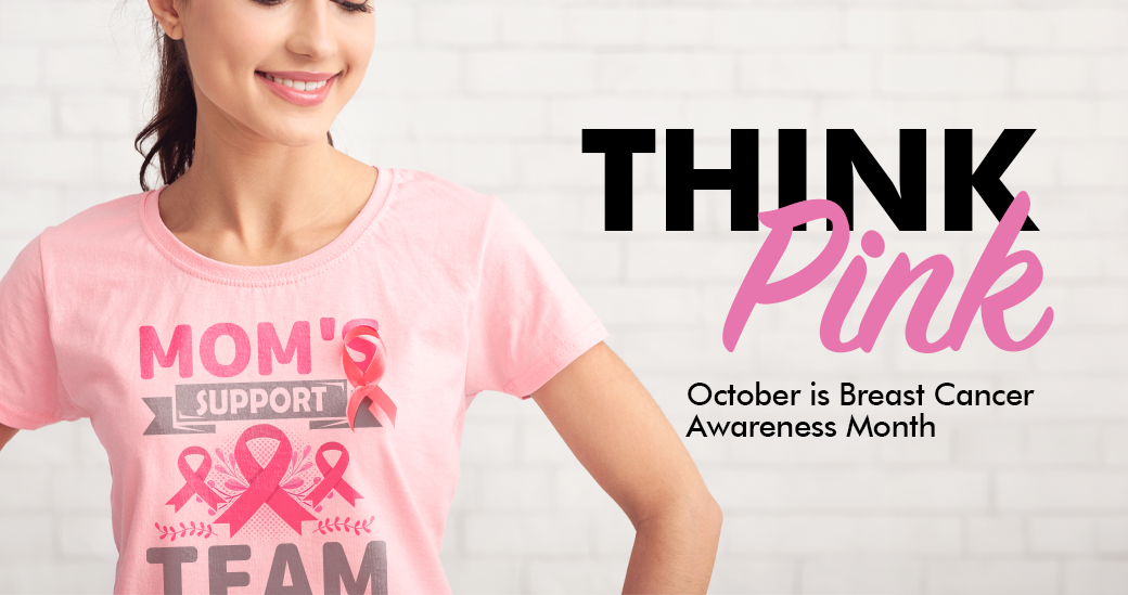 Image of Woman smiling and looking down while wearing a breast cancer awareness month t-shirt.
