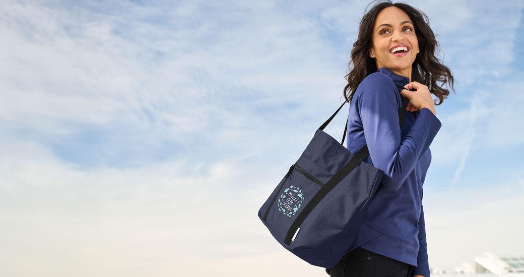 corporate gifts featuring smiling woman carring an imprinted tote bag