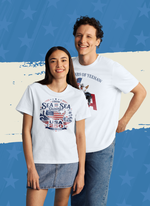 Image of man and a woman standing straight towards the camera. Both are smiling and wearing white t-shirts with patriotic designs.