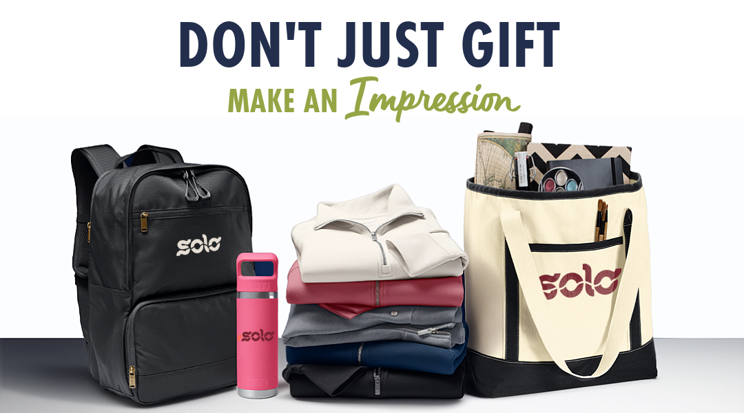 The words, "Don't Just Gift, Make An Impression" hovering over Branded backpack, water bottle, folded stack of shirts, quarter zips and jackets, and a tote bag filled with other smaller gifts like a journal and pens.